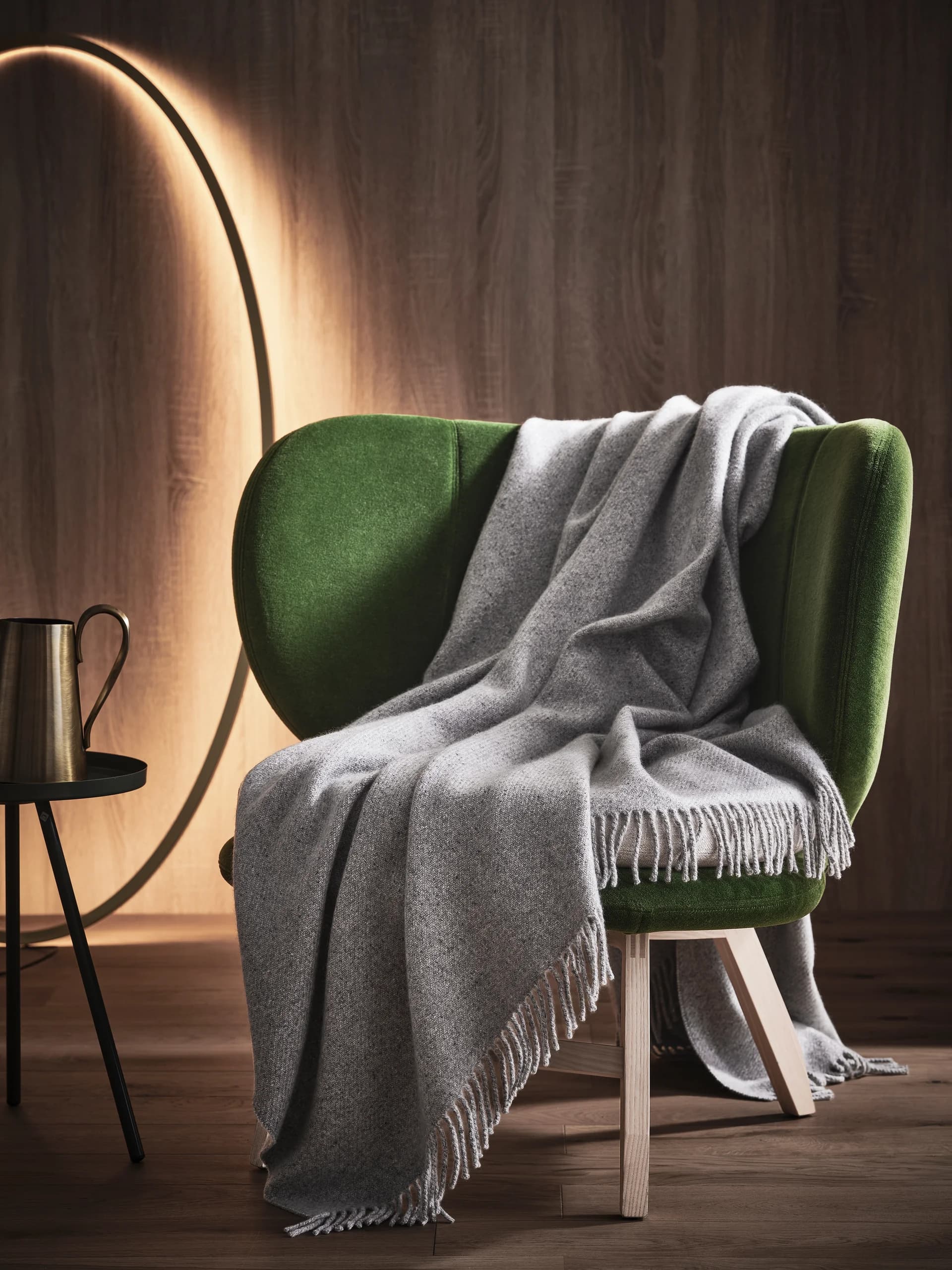 A soft, luxurious cashmere throw draped over a chair.